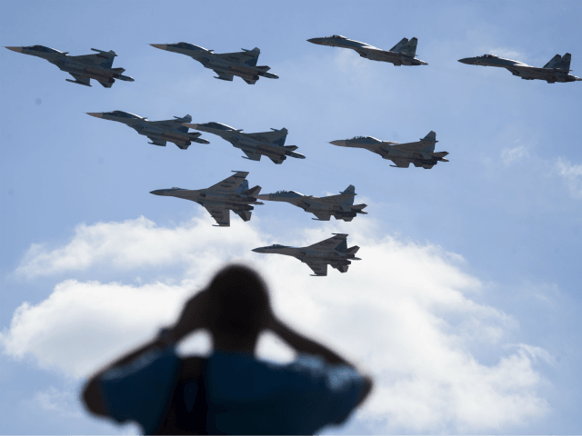 In this file photo taken on Saturday, Aug. 12, 2017 a man watches Russian military jets pe