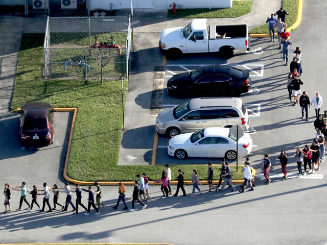 Students are evacuated by police out of Stoneman Douglas High School in Parkland, Fla., after a shooting on Wednesday, Feb. 14, 2018. (Mike Stocker/Sun Sentinel/TNS via Getty Images)