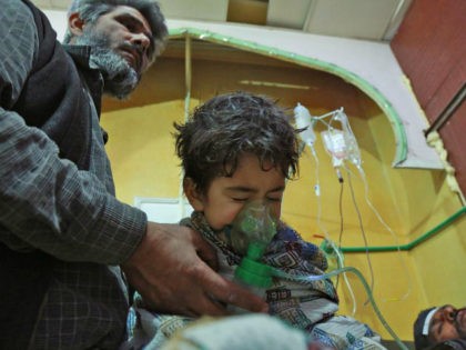 Syrian children and adults receive treatment for a suspected chemical attack at a makeshift clinic on the rebel-held village of al-Shifuniyah in the Eastern Ghouta region on the outskirts of the capital Damascus late on February 25, 2018. A child died and at least 13 other people suffered breathing difficulties …