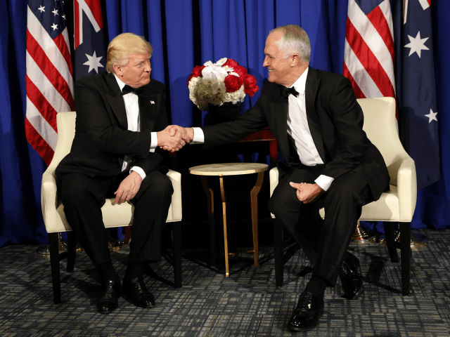President Donald Trump shakes hands with Australian Prime Minister Malcolm Turnbull aboard