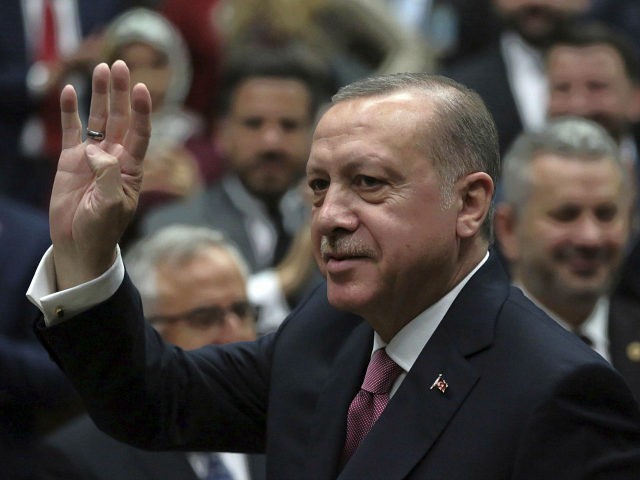 Turkey's President Recep Tayyip Erdogan waves as he arrives to address members of his ruli