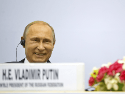 Russian President Vladimir Putin share a laugh as they attend a session of the World Diamond Conference in New Delhi, India, Thursday, Dec. 11, 2014. Putin was holding talks with Indian leaders Thursday to strengthen trade and energy cooperation with Asia's third-largest economy as Western sanctions threaten to push his …