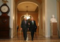 The Democratic Senate Minority Leader Charles Schumer (L) and Republican Senate Majority Leader Mitch McConnell walk side-by-side to the Senate Chamber on February 7, 2018 Hours from deadline, US Senate to vote to avert shutdown