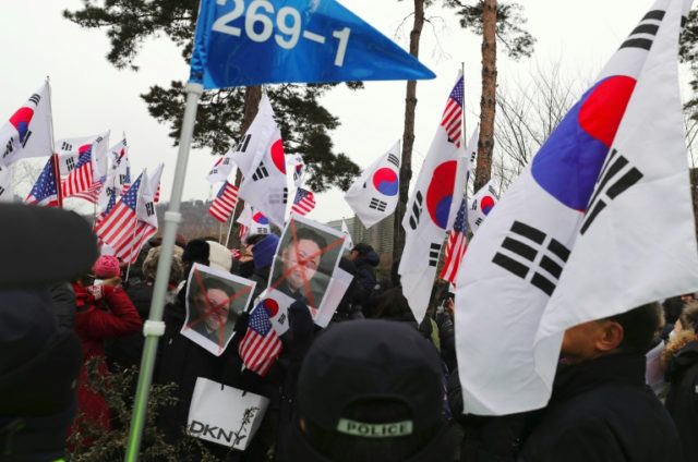 Protesters burn N. Korean flag before concert in Seoul