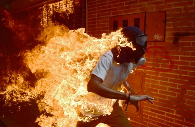 Fiery Venezuela image wins AFP photographer top award nod