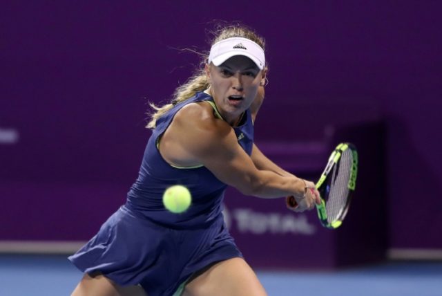 Worried Halep wins on return in Qatar, Wozniacki eases