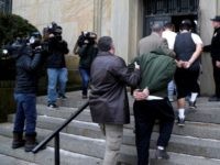 AP_18011747280792 Law Enforcement officers bring MS-13 gang members to court.