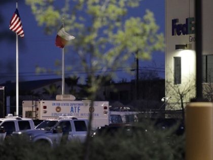 An ATF vehicle sits in front of a FedEx distribution center where a package exploded, Tuesday, March 20, 2018, in Schertz, Texas. Authorities believe the package bomb is linked to the recent string of Austin bombings. (AP Photo/Eric Gay)