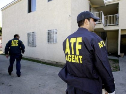 Alcohol, Tobacco and Firearms (ATF) officers inspect the grounds of an apartment building after tear gas was used during a raid in South Los Angeles Thursday, April 12, 2007. A two-year probe of the violent South Los Angeles street gang, the Neighborhood Crips, ended Thursday with 22 arrests, including one …