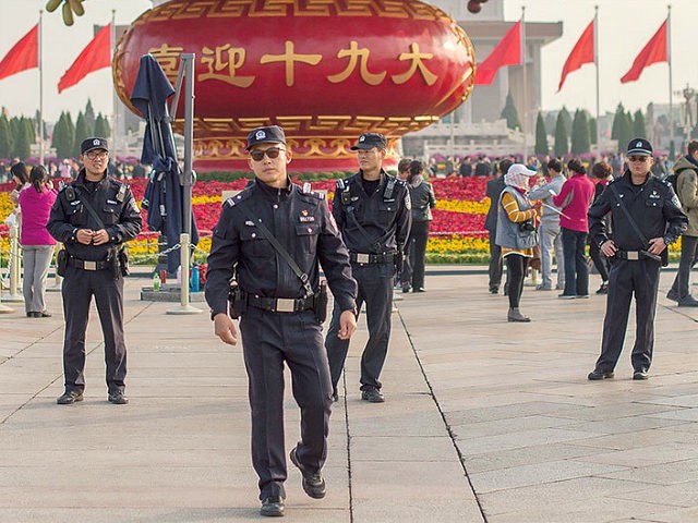 Chinese police patrol in Tiananmen square during the Communist Party's 19th Congress in Beijing on October 22, 2017. / AFP PHOTO / Nicolas ASFOURI (Photo credit should read NICOLAS ASFOURI/AFP/Getty Images)