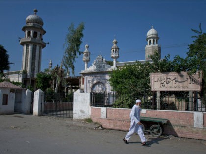 In this Wednesday, Oct. 26, 2011 photo, a man walks past the Islamic seminary Darul Uloom