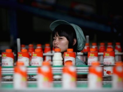 HANGZHOU, ZHEJIANG - JULY 02: A worker watches bottles of a Wahaha milk drink on a produc
