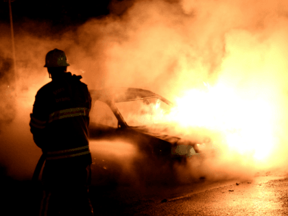 Firemen extinguish a burning car in Kista after youths rioted in few differant suburbs around Stockholm on May 21, 2013. Youths in the immigrant-heavy Stockholm suburb of Husby torched cars and threw rocks at police, in riots believed to be linked to the deadly police shooting of a local resident. …