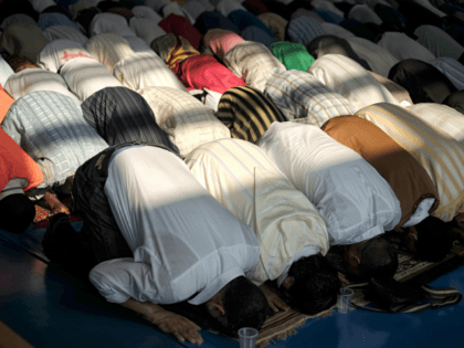 People pray during a celebration of Eid al-Fitr marking the end of the fasting month of Ra
