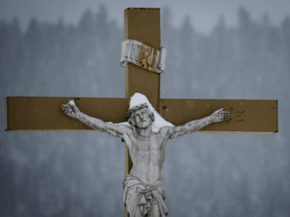 A picture taken on January 17, 2017 shows a snow-covered crucifix outside a church in the