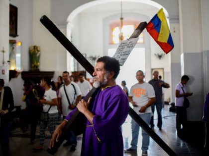 A Catholic faithful visits Santa Teresa basilica in Caracas during the celebration of the Nazarene of Saint Paul, part of the Holy Week festivities, on April 12, 2017. / AFP PHOTO / FEDERICO PARRA (Photo credit should read FEDERICO PARRA/AFP/Getty Images)