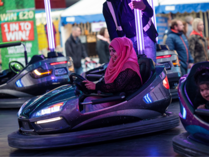 NOTTINGHAM, ENGLAND - OCTOBER 07: Visitors ride bumper cars at the Nottingham Goose Fair i