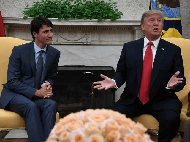 US President Donald Trump (R) speaks during a meeting with Canadian Prime Minister Justin