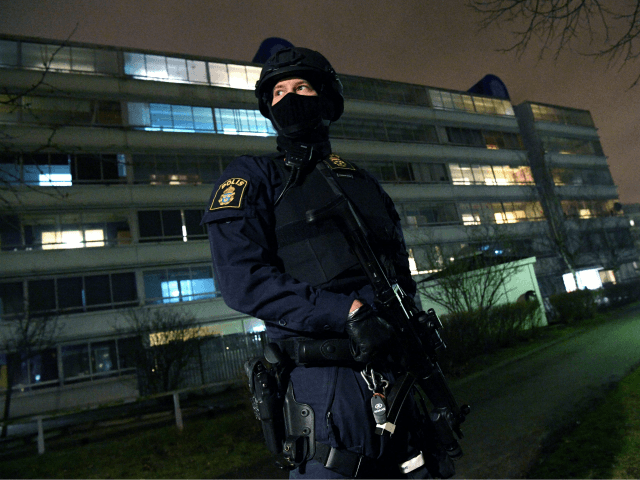 An armed police officer stands guard after an object exploded next to a police station in Rosengard in Malmo, Sweden on January 17, 2018. / AFP PHOTO / TT News Agency / Johan NILSSON / Sweden OUT (Photo credit should read JOHAN NILSSON/AFP/Getty Images)