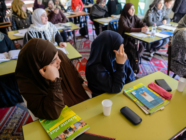HALLE, GERMANY - FEBRUARY 14: Muslim women from Syria take part in a German lesson in the Muslim cultural center and mosque as Aydan Ozoguz (not pictured), German Federal Commissioner for Immigration, Refugees and Integration visits the center and mosque following a recent attack on February 14, 2018 in Halle …