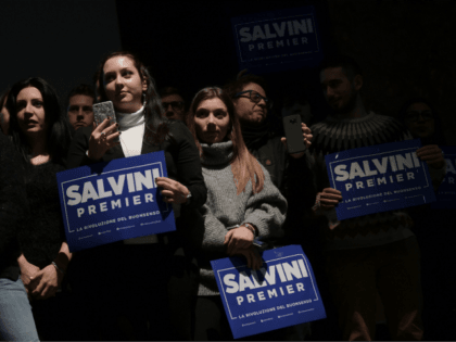 Supporters of the Northern League leader Matteo Salvini hold a banner during an elections