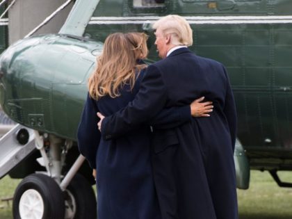 TOPSHOT - US President Donald Trump walks with First Lady Melania Trump after she tripped on the South Lawn of the White House in Washington, DC, on March 19, 2018.