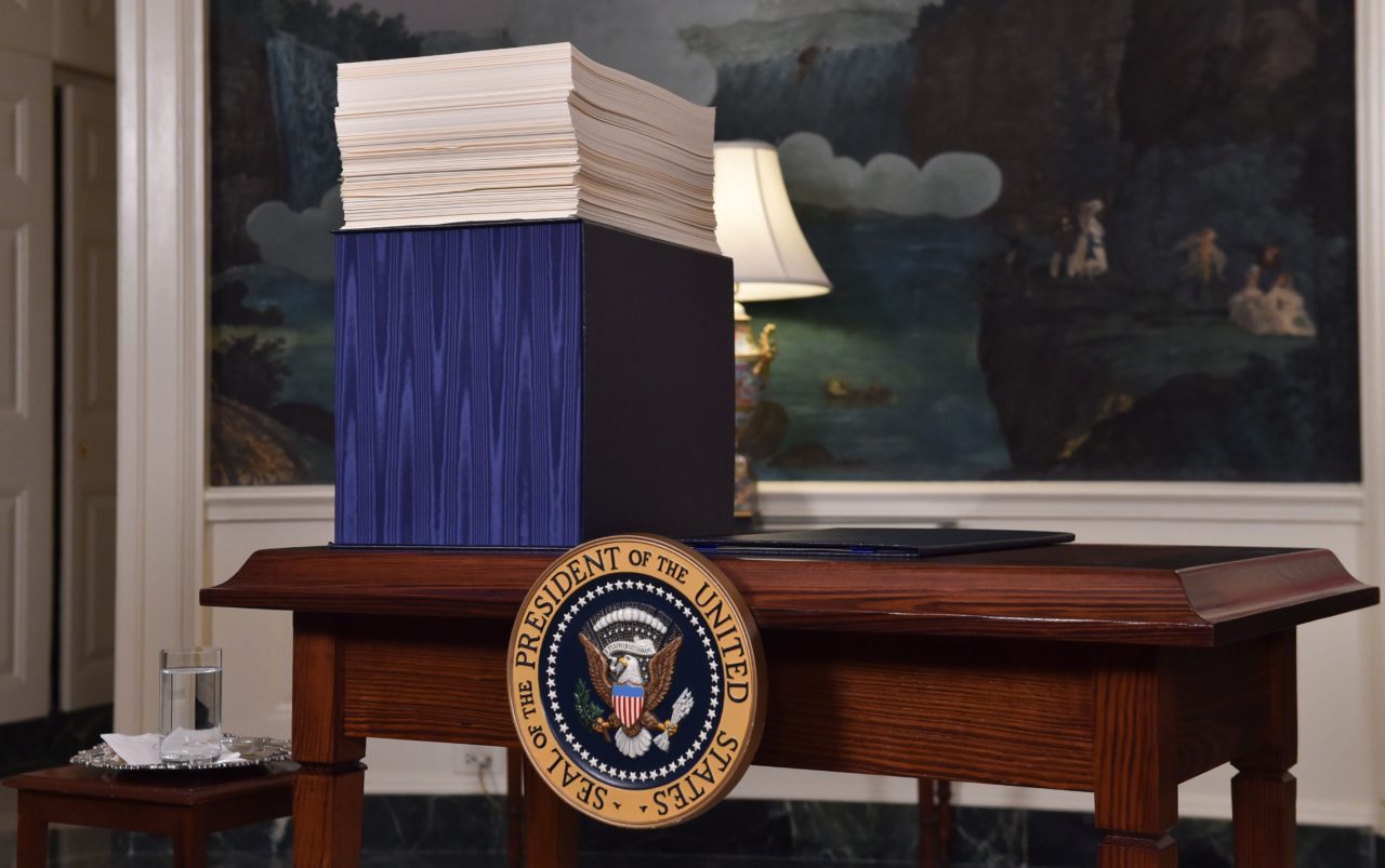 A copy of the spending bill, approved by Congress, is seen on a desk before US President Donald Trump speaks about the bill in the Diplomatic Room at the White House on March 23, 2018. / AFP PHOTO / Nicholas Kamm (Photo credit should read NICHOLAS KAMM/AFP/Getty Images)