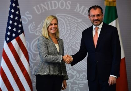 Mexican Minister of Foreign Affairs Luis Videgaray (R) shakes hands with US Secretary of H