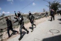 PALESTINIAN-ISRAEL-GAZA-CONFLICT EDITORS NOTE: Graphic content / Palestinian fighters from the Fatah movement march with Kalashnikov assault rifles during a funerary procession for 27-year-old farmer Omar Samour, who was killed earlier in the day by Israeli tank fire, in Khan Yunis, in the southern Gaza Strip on March 30, 2018. Local witnesses …