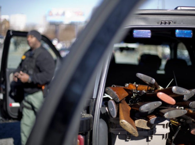 Rifles are piled up in the back of a Fulton County Sheriff's vehicle collected during a gun buyback, Thursday, Jan. 16, 2014, in Atlanta. The NAACP is looking to collect 1,000 firearms during the gun buyback which is part of NAACP programs centered on non-violence leading up to Martin Luther …