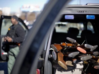 Rifles are piled up in the back of a Fulton County Sheriff's vehicle collected during a gun buyback, Thursday, Jan. 16, 2014, in Atlanta. The NAACP is looking to collect 1,000 firearms during the gun buyback which is part of NAACP programs centered on non-violence leading up to Martin Luther …