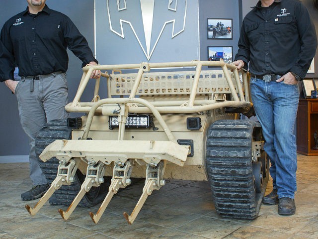 WATERBORO, ME - DECEMBER 20: Howe and Howe Technologies has secured a contract to build twenty RS2H1 robots for the U.S. military. Michael Howe, left, and Geoffrey pose with the robot vehicle at their business in Waterboro. (Photo by Derek Davis/Staff photographer)