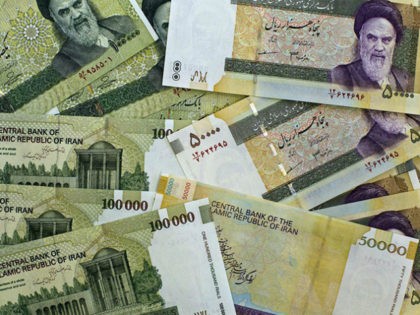A picture taken on April 11, 2011 shows Iran's biggest denomination currencies, 100000 Rials (8.9 US dollars) and 50000 Rials (4.45 US dollars) in Tehran. Iran plans to slash four zeroes from the national currency in 'one or two years', seeking parity between its rial and the US dollar, Central …