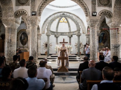 Iraqi Syriac Christian priest Charbel Aesso leads an easter service at Saint John's Church