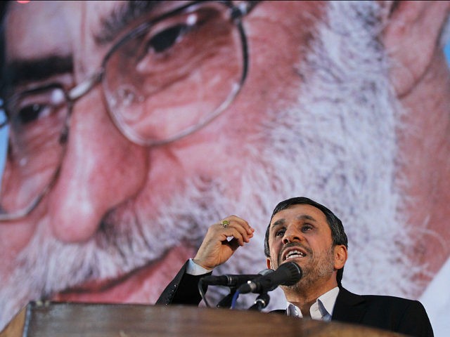 Iranian President Mahmoud Ahmadinejad delivers a speech under a portrait of Iran's supreme leader, Ayatollah Ali Khamenei, on the eve of the 23nd anniversary of the death of their revolutionary leader Ayatollah Ruhollah Khomeini on June 2, 2012. AFP PHOTO/ATTA KENARE (Photo credit should read ATTA KENARE/AFP/GettyImages)