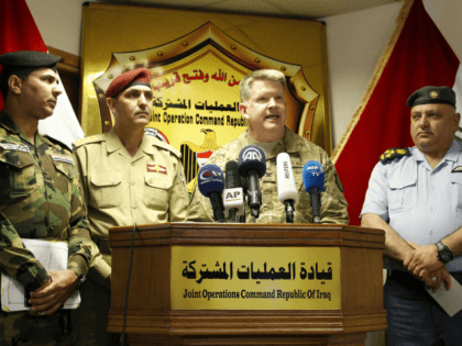 US Air Force Colonel John L. Dorrian (C), spokesman for Combined Joint Task Force - Operation Inherent Resolve, the US-led coalition fighting the Islamic State (IS) group in Iraq and Syria, speaks during a press conference in the capital Baghdad on April 11, 2017, accompanied by Brigadier General Yahya Rasool …