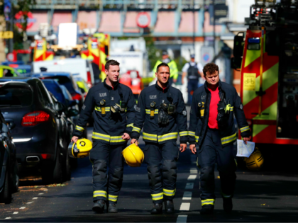 Members of the London Fire Brigade emergency service work near Parsons Green underground tube station in west London on September 15, 2017, following an incident on an underground tube carriage at the station. At least 22 people were injured after a bomb detonated on a packed London Underground train at …