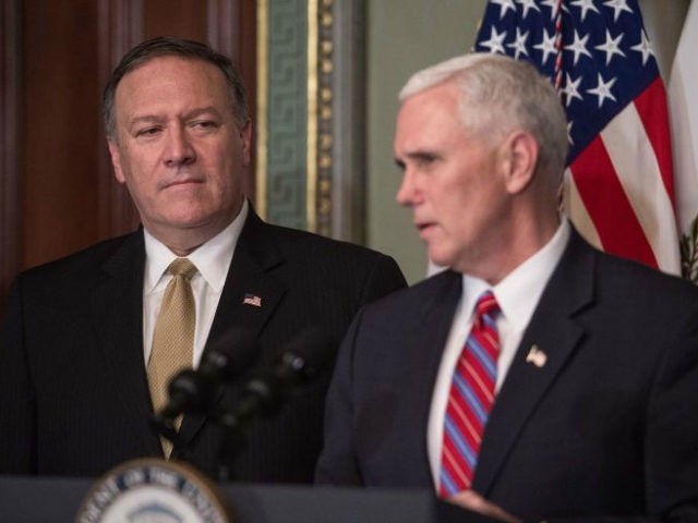 Newly confirmed CIA director Mike Pompeo (L) listens to US Vice President Mike Pence before being sworn in in the Vice President's Ceremonial Office at the Eisonhower Executive Office Building on January 23, 2017 in Washington, DC. / AFP / NICHOLAS KAMM (Photo credit should read NICHOLAS KAMM/AFP/Getty Images)