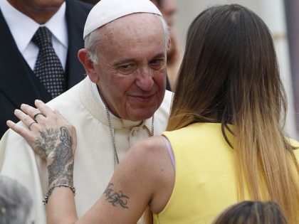 Pope greets woman with tattoos