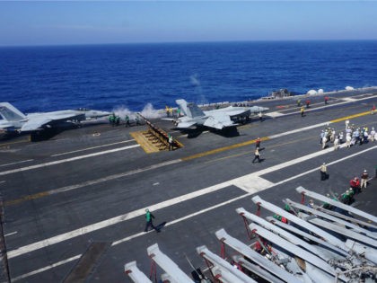 This general view shows the flight deck of the aircraft carrier USS Carl Vinson on February 14, 2018, as the carrier strike group takes part in a routine deployment mission in the South China Sea, one hour away from Manila. With a deafening roar and earthshaking vibrations, fighter jets zoomed …