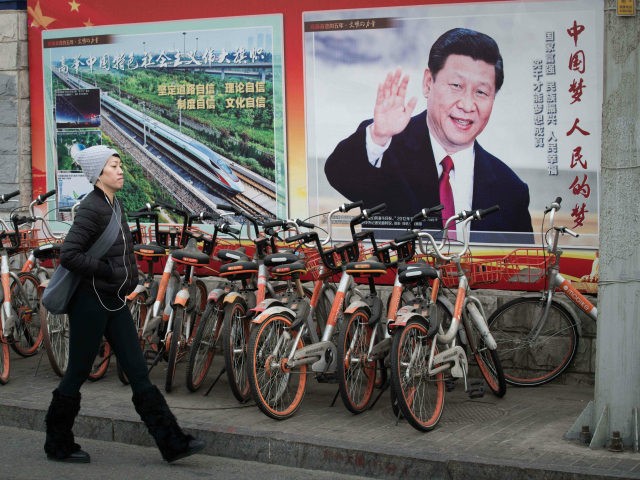 A propaganda poster showing China's President Xi Jinping is pictured on a wall in Beijing on March 12, 2018. China's Xi Jinping on March 11 secured a path to rule indefinitely as parliament abolished presidential term limits, handing him almost total authority to pursue a vision of transforming the nation …