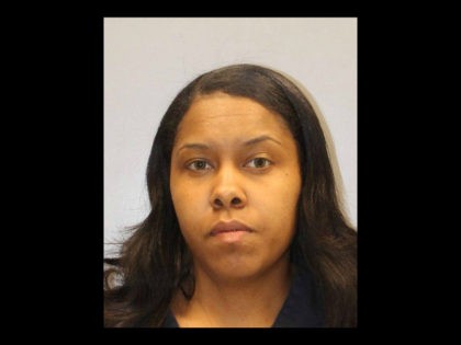 Police allege that Aisha Evans, a school custodian, rummaged through students' unattended