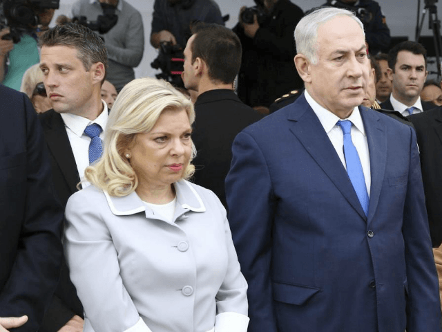 Israeli Prime Minister Benjamin Netanyahu, center, and his wife Sara, left, stand beside V