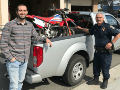 Kamron Golbaf retrieving his motorcycle from CHP officer Ralph Villegas at the Temecula station.