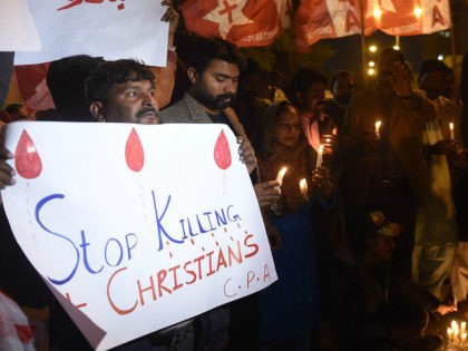 Pakistani Christians hold banners and lighted candles during a protest in Karachi on December 17, 2017, after a suicide bomber attack on a church in Quetta. At least eight people were killed and 15 wounded when two suicide bombers attacked a church in Pakistan during a service on December 17, …