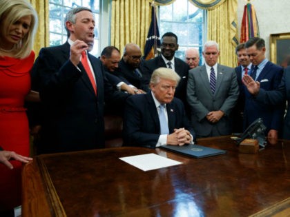 Faith leaders pray with President Donald Trump after he signed a proclamation for a nation