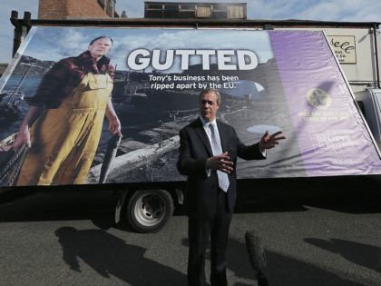GRIMSBY, UNITED KINGDOM - APRIL 08: United Kingdom Independence Party (UKIP) leader Nigel Farage unveils UKIP's latest campaign poster in support of the fishing industry during campaigning on April 8, 2015 in Grimsby, United Kingdom. During his vist to the northern fishing port Farage announced in Grimsby that a system …