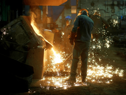 Moulders fill their ladles with molten iron at Kirkpatrick Foundry on February 21, 2018 in