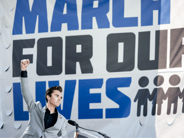 David Hogg, a survivor of the mass shooting at Marjory Stoneman Douglas High School in Parkland, Fla., raises his fist after speaking during the "March for Our Lives" rally in support of gun control in Washington, Saturday, March 24, 2018. (AP Photo/Andrew Harnik)