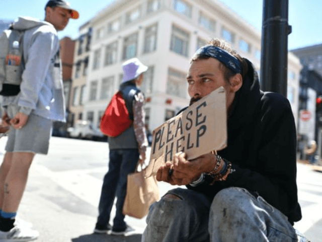 Andrew Loy begs along a sidewalk in downtown San Francisco on June, 28, 2016. Homelessness is on the rise in the city, which has some of the highest housing costs in the nation.